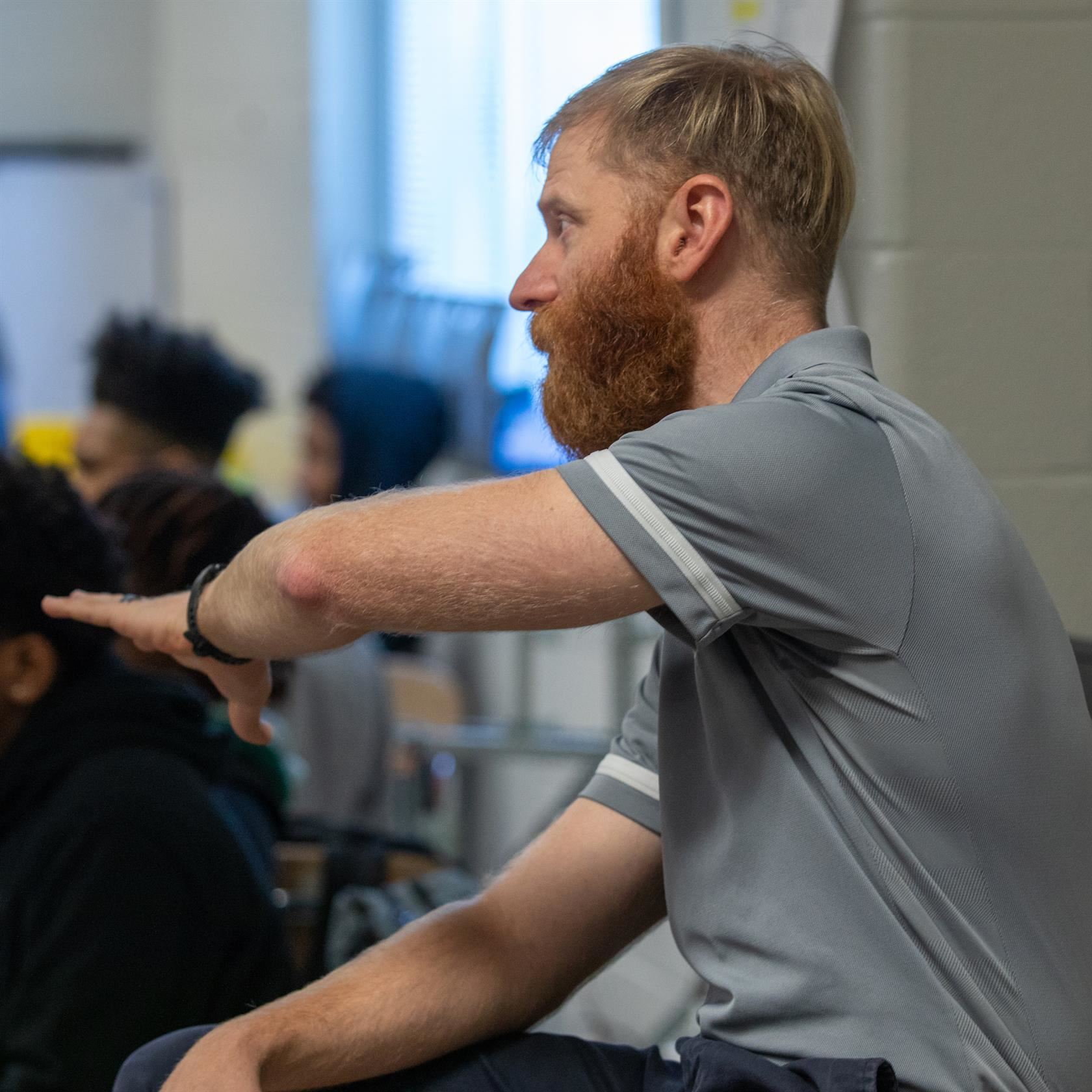  A career academy teacher gives a lecture to his students.